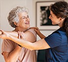 Nurse helping senior resident stretch arm