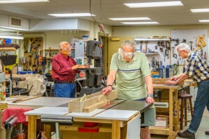 Residents working in the community woodworking shop